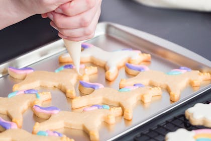 Decorating unicorn shaped biscuits