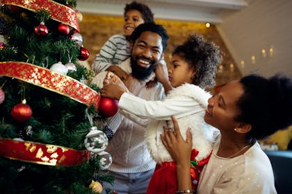 Family decorating the Christmas tree