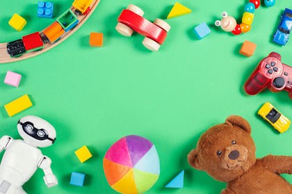 Selection of toys on green background