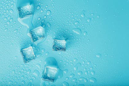 Five ice cubes on a blue background
