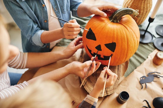 Family painting a pumpkin