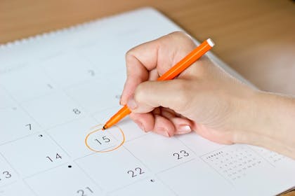 woman circling date on calendar
