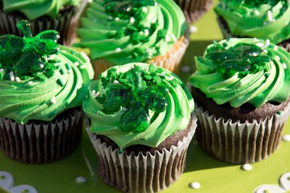 Cupcakes decorated with green icing and jelly shamrocks for St Patrick's Day