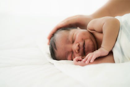 Newborn baby smiling in her sleep