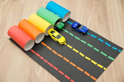 Coloured toilet rolls with the same colour toy cars inside them