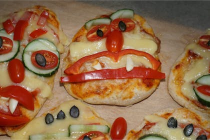 Pizzas decorated with scary faces for Halloween