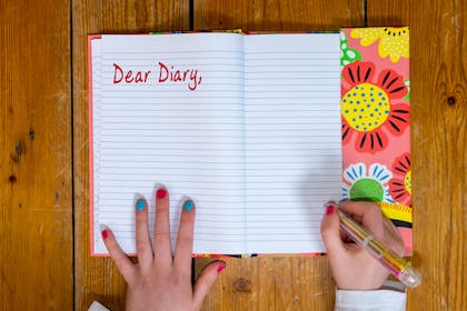Child writing in a diary