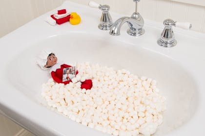 Elf on the Shelf taking a marshmallow bath in bathroom sink