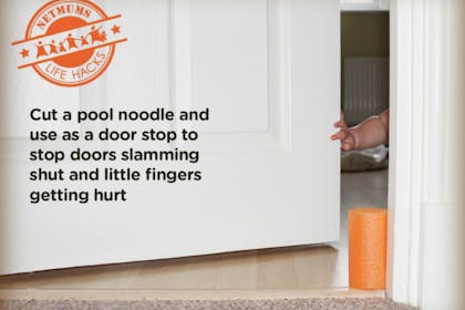 child's hand and pool noodle in door