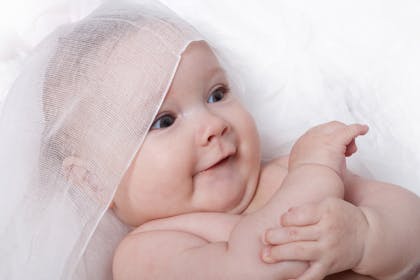Smiling baby with veil