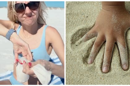 Mum holding sock on beach | Hand in sand