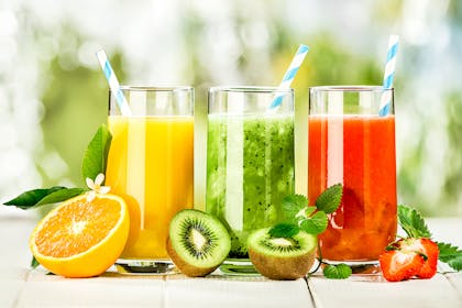 Selection of three different juices with fruit