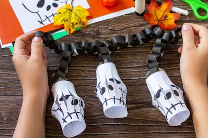 Halloween craft activity making paper skeleton lanterns and black paper chain