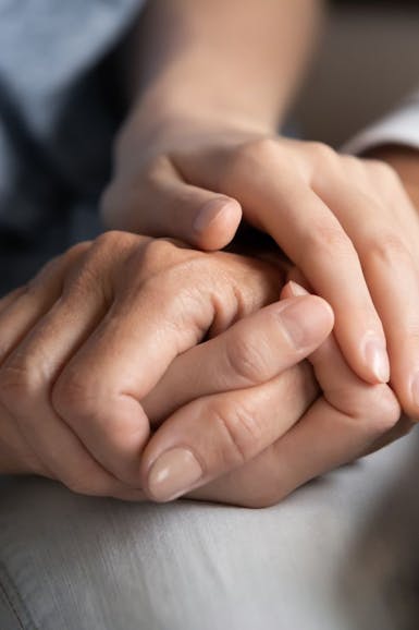 Women holding hands to illustrate the Netmums Drop In Clinic and Parent Support Service