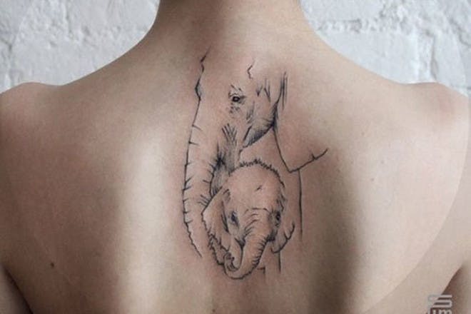 Elephants on neck tattoo