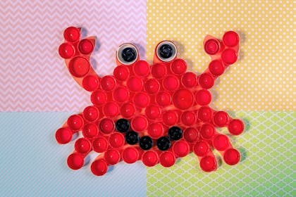 Picture of a crab made from old bottle tops and buttons