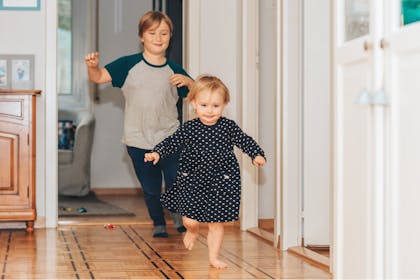 Kids play chase game around house