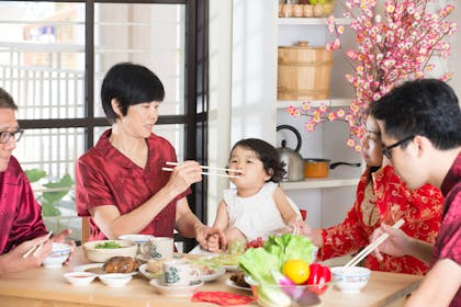 Chinese New Year feeding baby with chopsticks