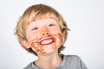 young boy with chocolate on face