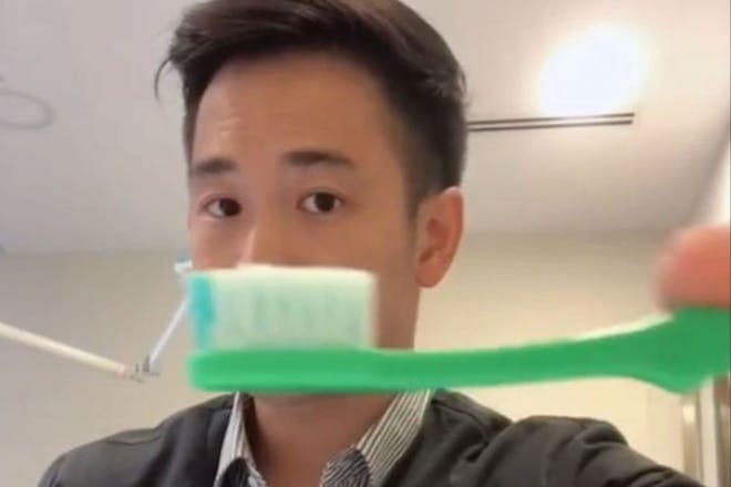 Dentist showing a smear of toothpaste on a toothbrush on Tik Tok