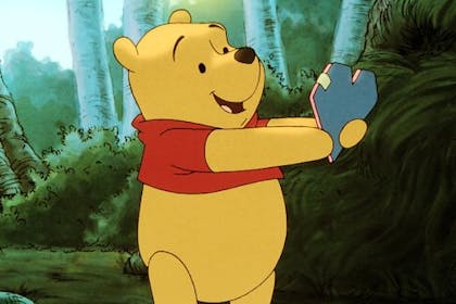 Winnie the Pooh holding a love heart in the movie, Winnie the Pooh: A Valentine for You 