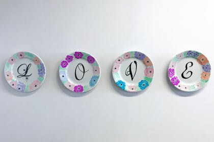 Four Sharpie plates reading L O V E
