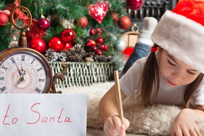 little girl writing letter to santa