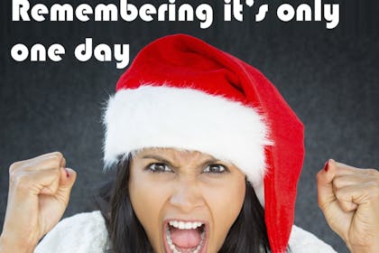 woman with christmas hat on screaming