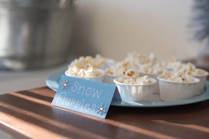 Small cups of popcorn made to look like snow flurries for kids party