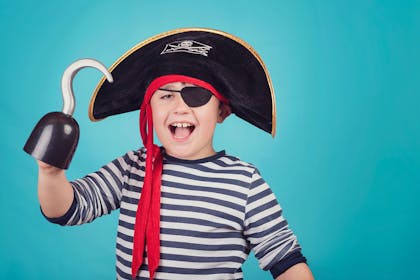 Boy with pirate outfit and plastic hook on hand