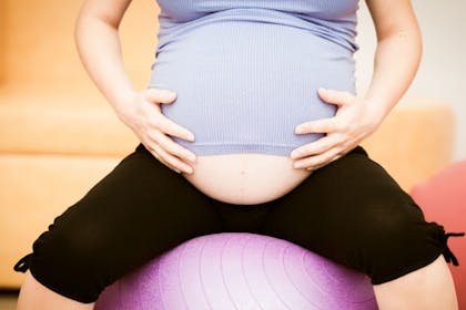 pregnant woman using exercise ball