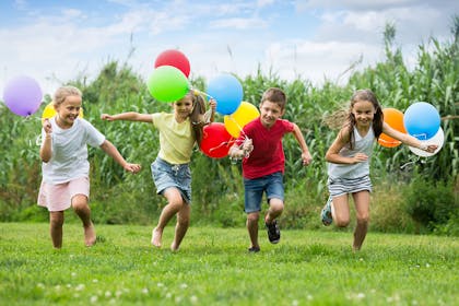 Kids running with balloons