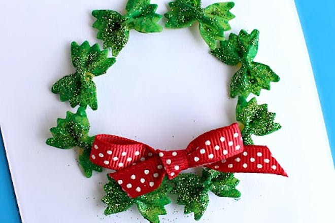 Christmas wreath card made out of green bow tie pasta 