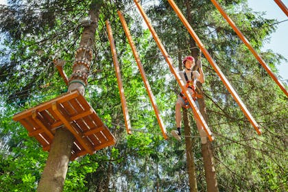 teenager on a high-rope obstacle course