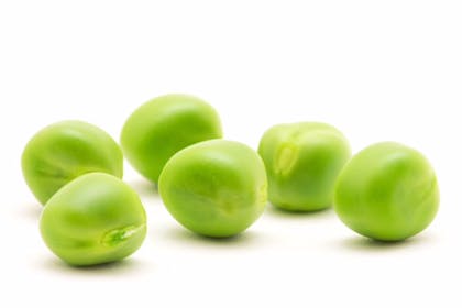 Six marrowfat peas on a white background 