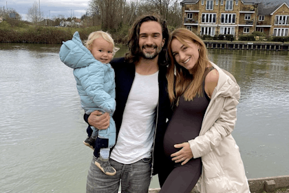 Joe and Rosie Wicks cuddle while holding baby
