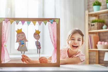 Girl doing puppet show with homemade puppets