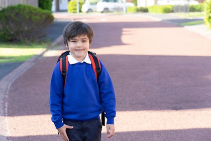 Little boy smiling wearing school uniform