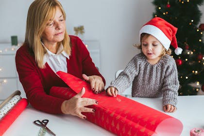 Mum and child wrapping a present