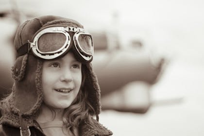 girl wearing vintage pilot goggles and trapper hat