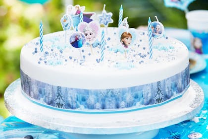 White birthday cake topped with Frozen decorations