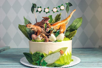 Cake with toy dinosaurs on top