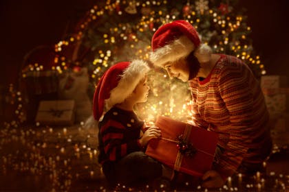 Mother and son opening presents at Christmas 