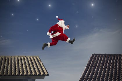 Santa jumping from roof to roof on Christmas Eve