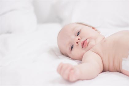 Baby lying on back looking relaxed