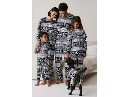 Family all wearing matching fairisle navy pyjamas from Next