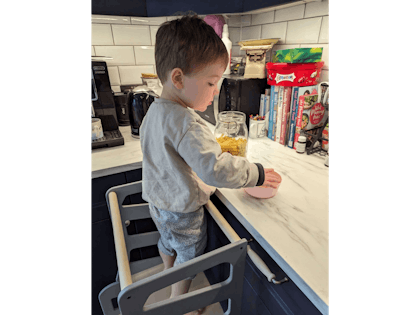 Child helping in kitchen