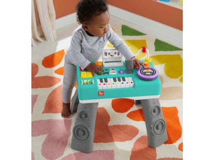 Toddler playing with Fisher-Price® Laugh & Learn® Mix & Learn DJ Table™