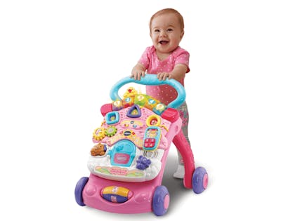 Toddler with VTech Baby First Steps Baby Walker in pink