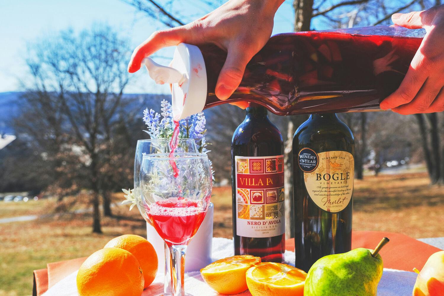 Someone pouring sangria into a glass on the Slope